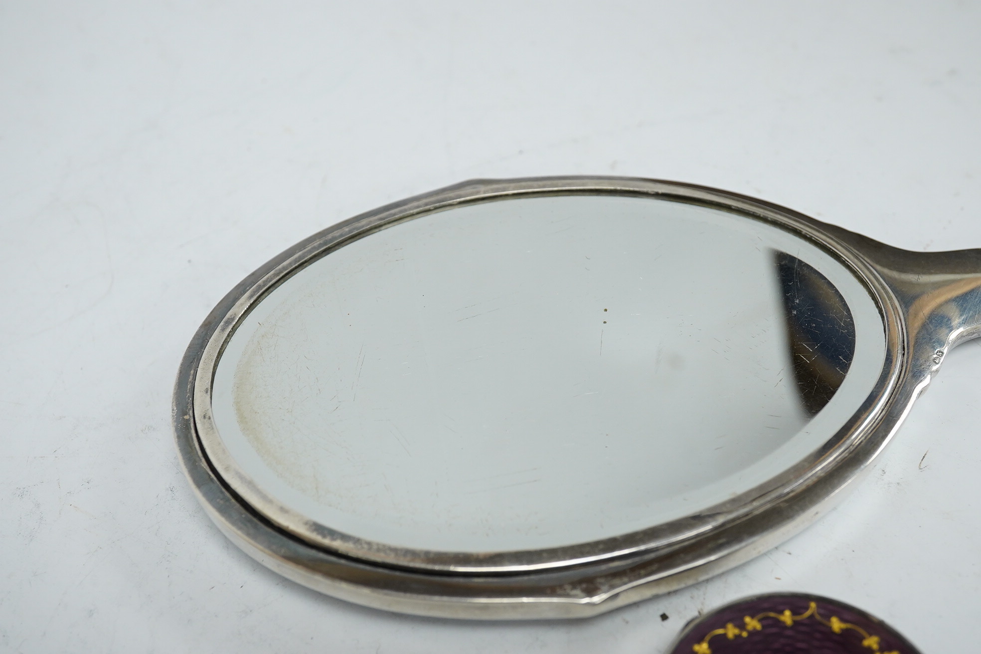 A George VI silver and enamelled hand mirror, by Daniel Manufacturing Company, Birmingham, 1947, 28.3cm, together with a Scandinavian 925 and enamel circular pill box. Condition - fair